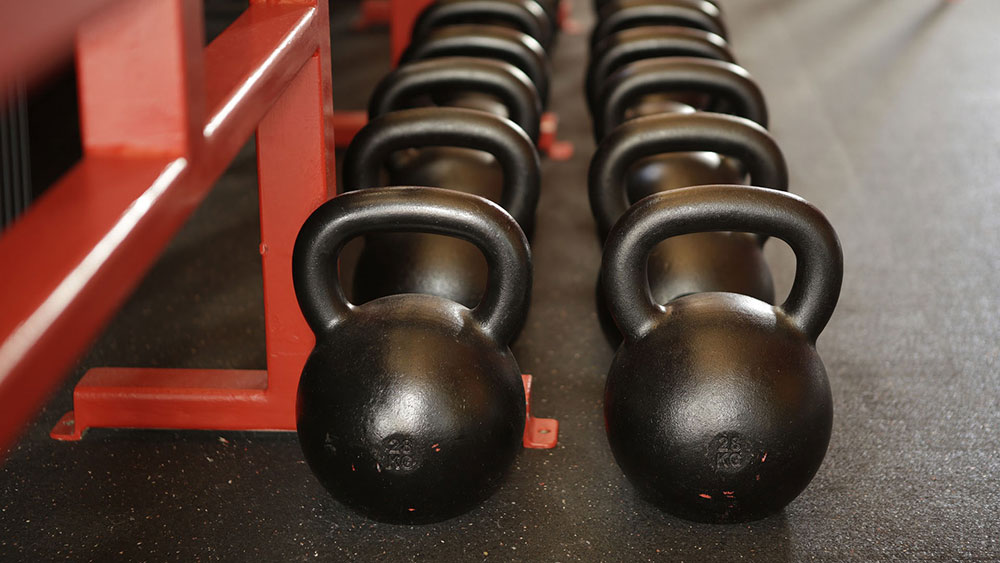 Image of kettle bell weights on a gym floor